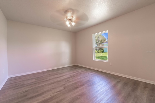 spare room featuring ceiling fan, a textured ceiling, and dark hardwood / wood-style floors