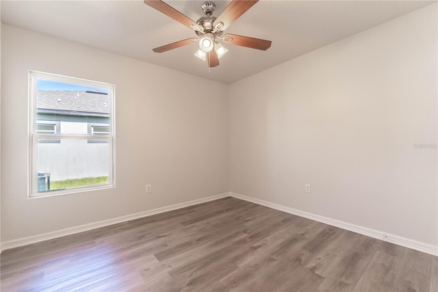 spare room featuring hardwood / wood-style floors and ceiling fan