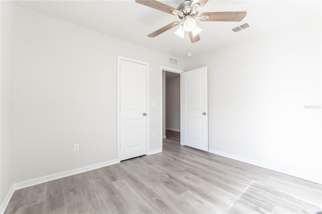 spare room featuring light hardwood / wood-style floors and ceiling fan