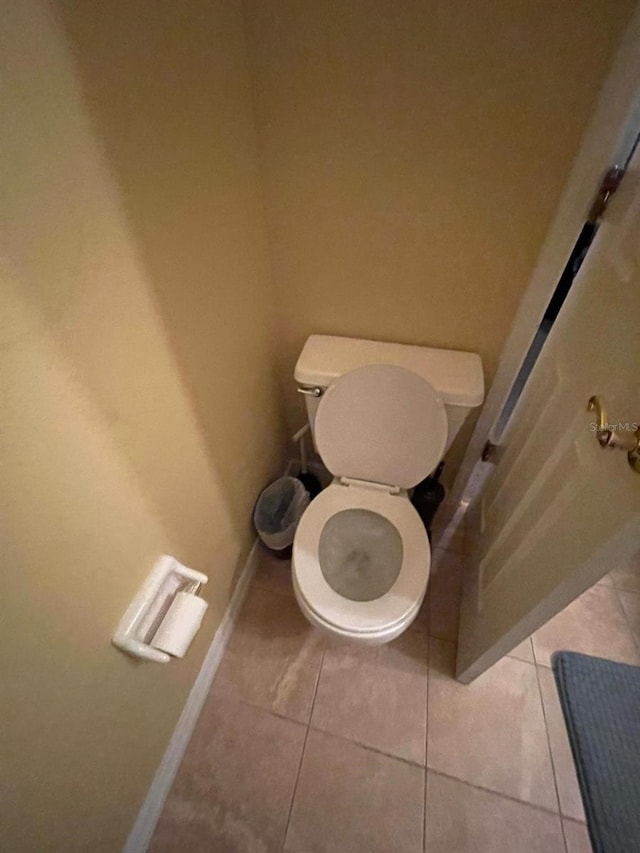 bathroom featuring tile patterned flooring and toilet