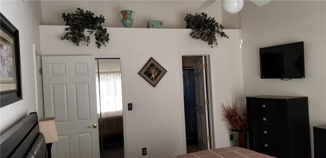 bedroom with ensuite bathroom and ceiling fan