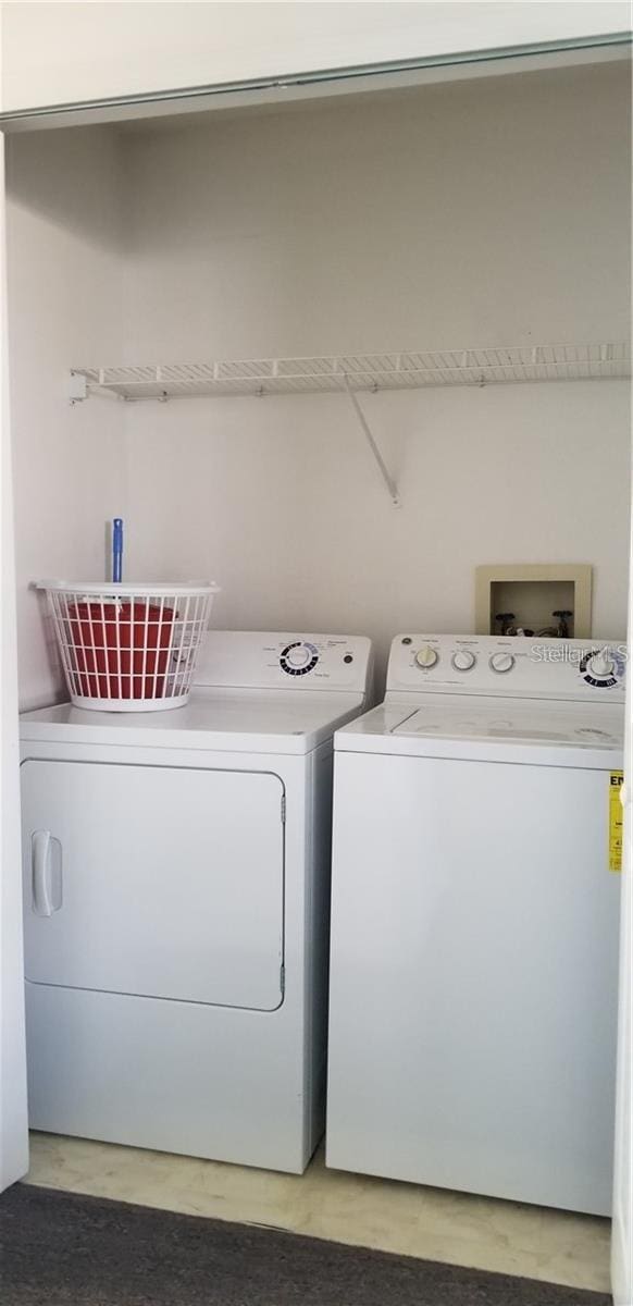 washroom with washing machine and clothes dryer