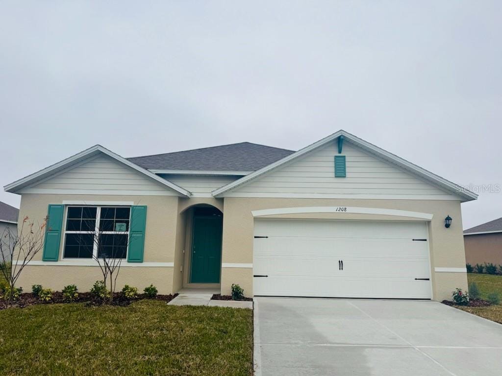 ranch-style house with a garage and a front yard