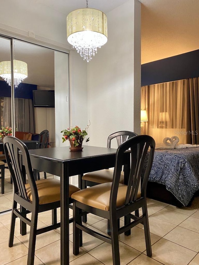 6165 Carrier Dr Unit 2113, Orlando, FL 32819 - dining area with a chandelier and light tile patterned flooring
