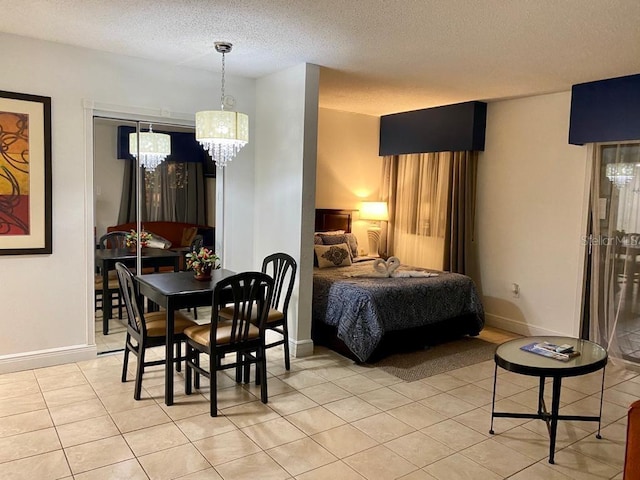 interior space with a notable chandelier, a textured ceiling, and light tile patterned floors