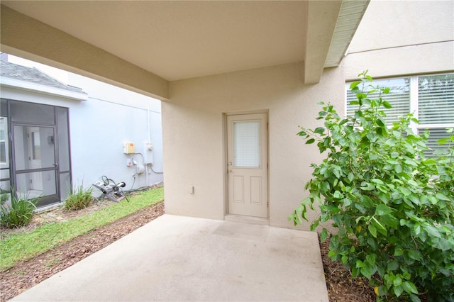 property entrance featuring a patio area