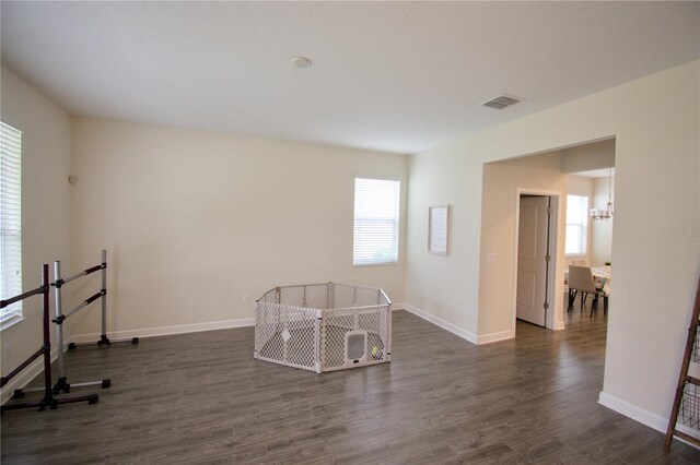 interior space featuring an inviting chandelier and dark hardwood / wood-style floors