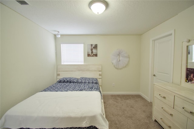 carpeted bedroom with a textured ceiling