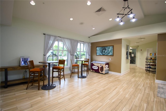 interior space featuring light hardwood / wood-style floors and lofted ceiling