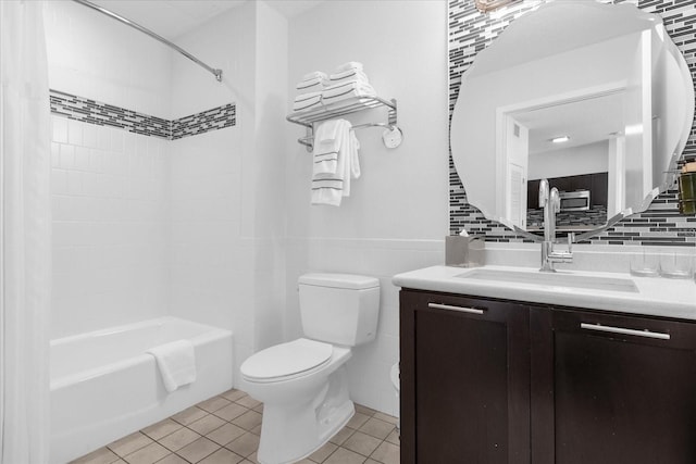 full bathroom with vanity, toilet, tile patterned floors, and tiled shower / bath combo