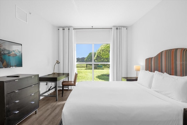 bedroom with dark wood-type flooring