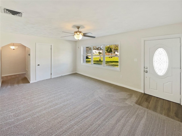 carpeted entryway with ceiling fan