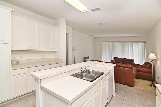 kitchen featuring white cabinets, sink, a center island with sink, and light tile patterned floors