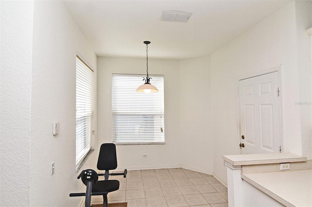 interior space featuring a healthy amount of sunlight and light tile patterned floors