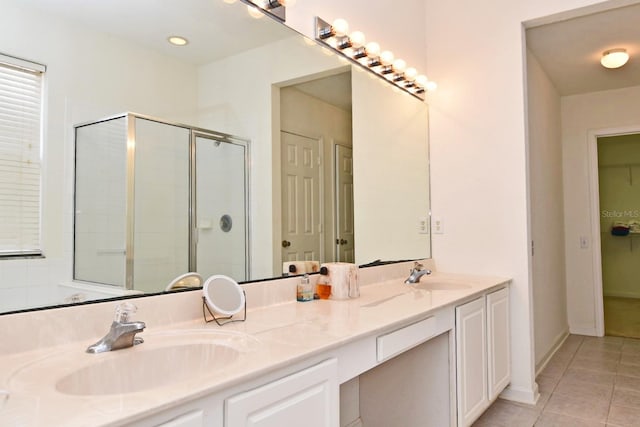 bathroom featuring vanity, an enclosed shower, and tile patterned floors