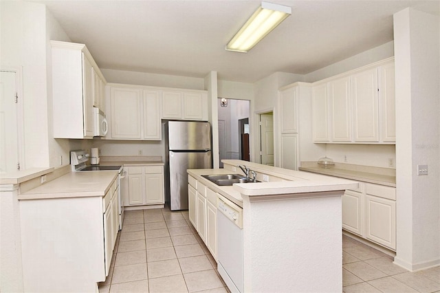 kitchen featuring a center island with sink, white cabinetry, and white appliances