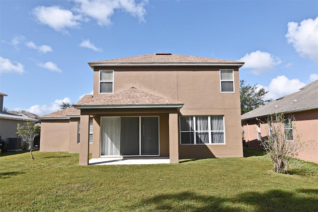 back of house with a patio area and a yard