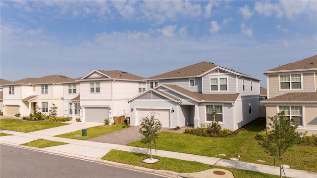 view of front of property featuring a garage and a front lawn