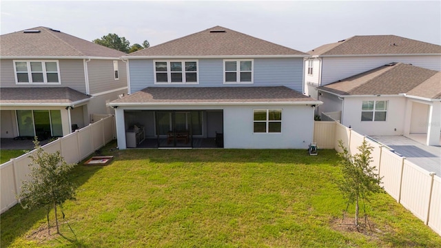 rear view of house with a patio area and a lawn