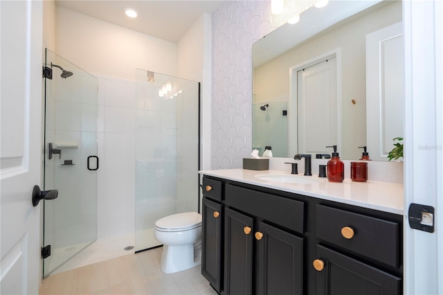 bathroom featuring vanity, a shower with shower door, toilet, and tile patterned floors