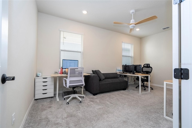 carpeted office with plenty of natural light and ceiling fan