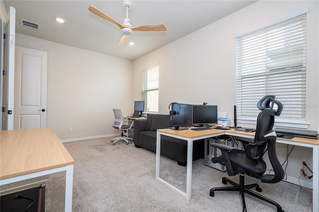 carpeted home office featuring ceiling fan