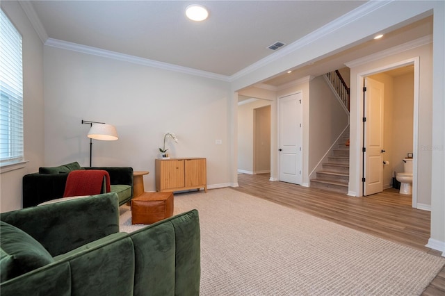 living room featuring wood-type flooring and ornamental molding