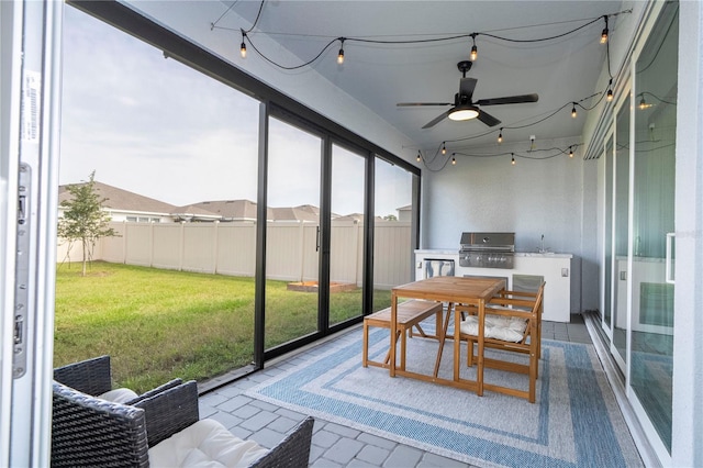 sunroom featuring ceiling fan