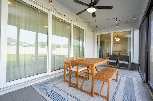 sunroom / solarium featuring ceiling fan