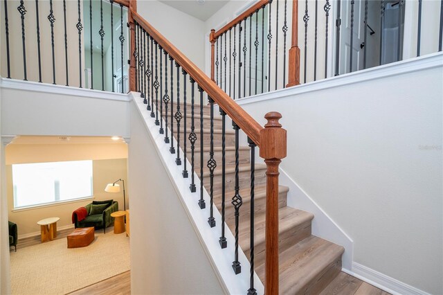 stairs featuring wood-type flooring