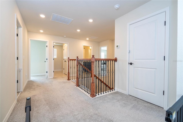 corridor with light colored carpet