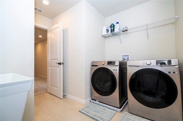 laundry area with washing machine and clothes dryer