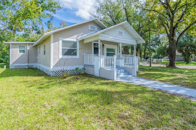 bungalow featuring a porch and a front lawn