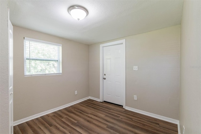 empty room featuring dark hardwood / wood-style floors