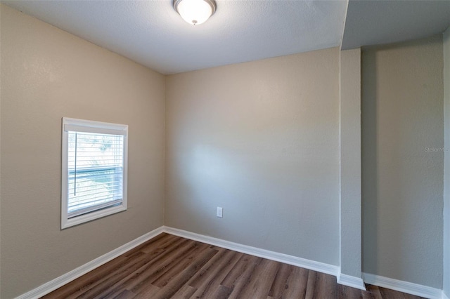 spare room with dark hardwood / wood-style floors