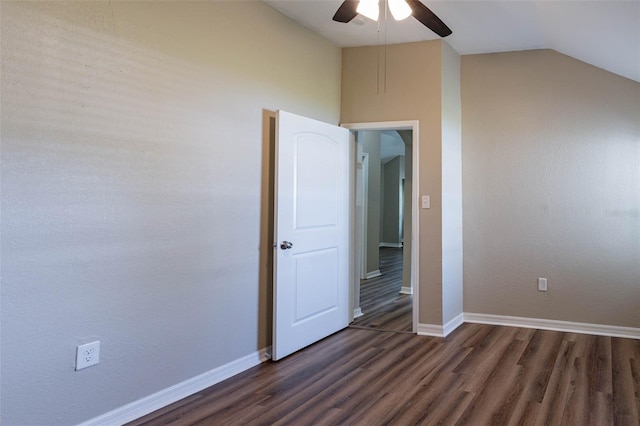 unfurnished bedroom featuring dark wood-type flooring, lofted ceiling, and ceiling fan