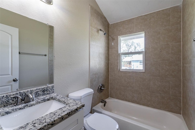 full bathroom featuring toilet, tiled shower / bath combo, and vanity