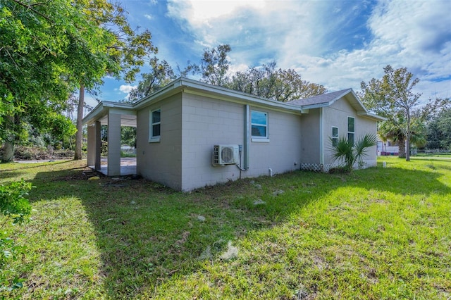 view of home's exterior featuring a yard and ac unit