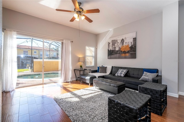 living room featuring hardwood / wood-style flooring and ceiling fan