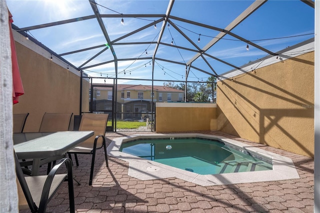 view of pool featuring a patio and glass enclosure