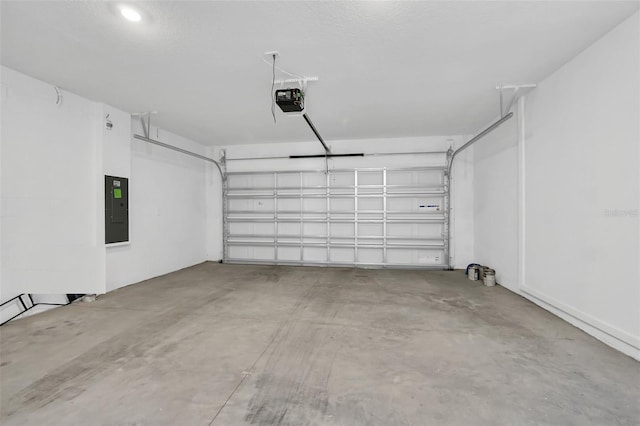 garage featuring electric panel and a garage door opener