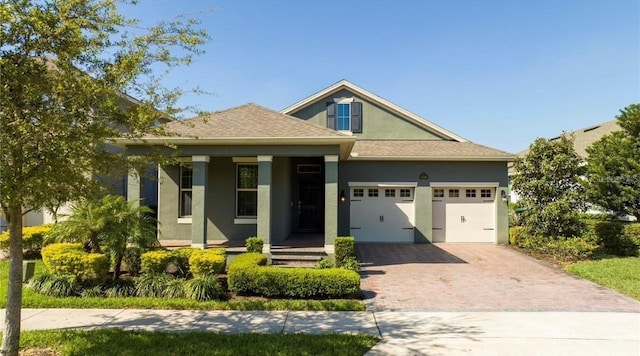 view of front of house featuring covered porch and a garage