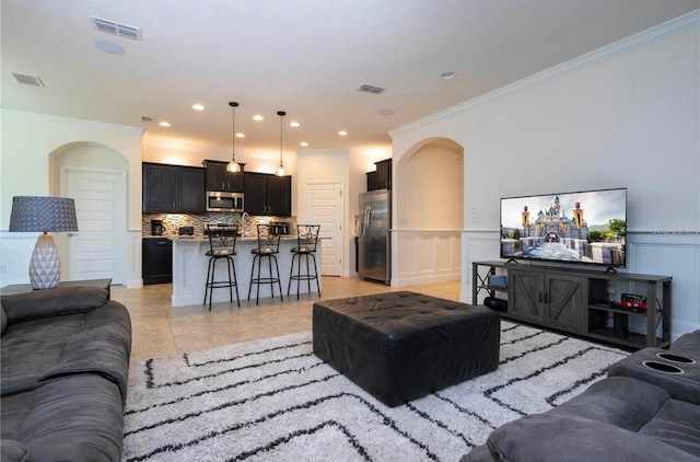 tiled living room featuring ornamental molding