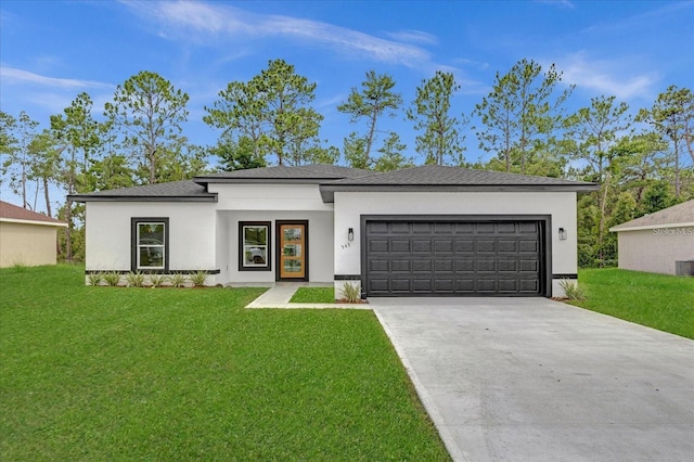 view of front of property featuring central air condition unit, a front yard, and a garage