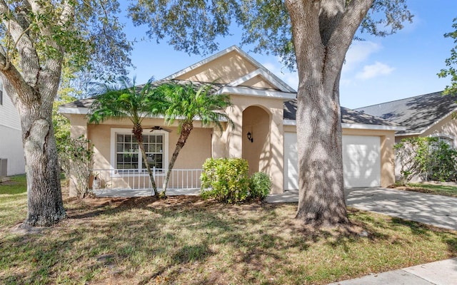 view of front of home with a garage and a front lawn