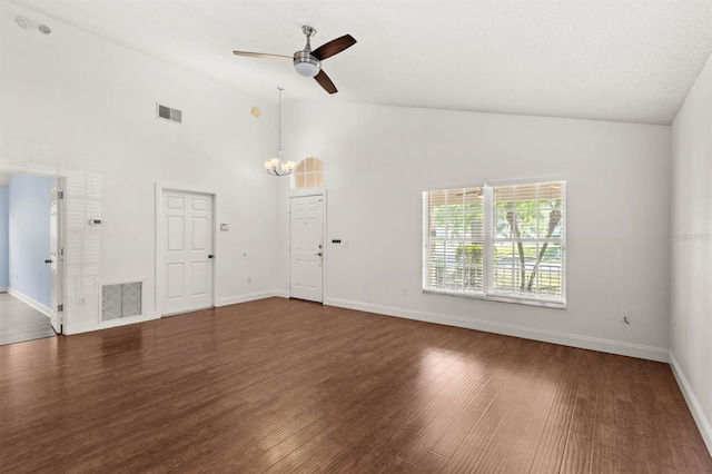 unfurnished living room with high vaulted ceiling, ceiling fan with notable chandelier, and dark hardwood / wood-style flooring