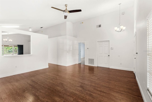 unfurnished living room featuring ceiling fan with notable chandelier, high vaulted ceiling, and dark hardwood / wood-style floors