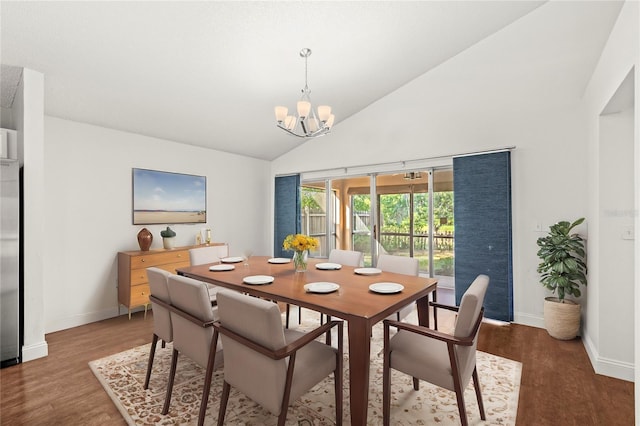 dining space with high vaulted ceiling, wood-type flooring, and an inviting chandelier