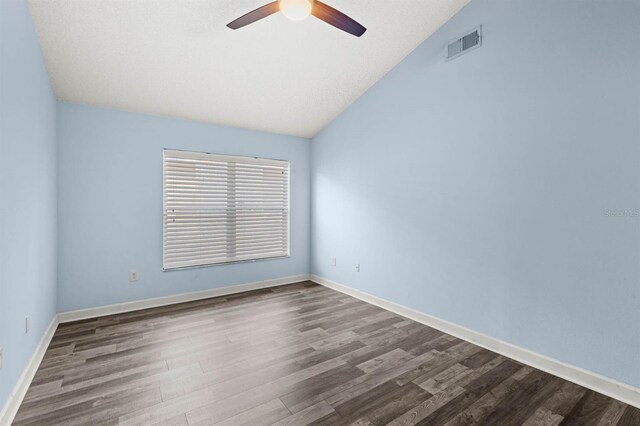 spare room featuring ceiling fan, a textured ceiling, vaulted ceiling, and hardwood / wood-style floors