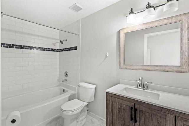 full bathroom featuring vanity, toilet, tiled shower / bath combo, and a textured ceiling